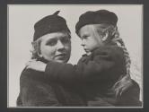 [Virginia Stevens carrying young girl in cemetery scene of "Native Land."]