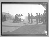 [judges inspecting auto at racetrack "#1"]
