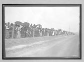 [spectators along road]