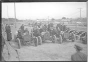 [autos lined up at track " #33, #34, #35"]