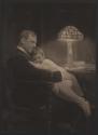 [Man and boy sitting in chair]