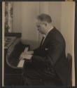 [Man playing piano]