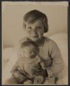 [Child holding doll]