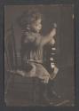 [Child holding violin]