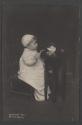 [Child sitting at table with teapot and cup]
