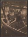 [Two women in boat, one holding camera]