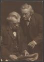 [Two men reading newspaper]
