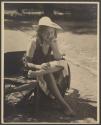 [Girl sitting on wheelbarrow]