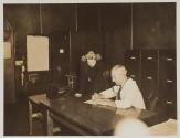 [Man and woman at desk]