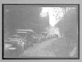 [auto tour lined up on road]