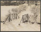 [Footbridge in snowy landscape]