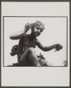 [View of statue of girl holding a shell to her ear.]