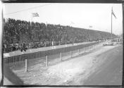 [spectator stands at track]