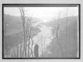 [train passing along river]