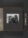 [Man drying his eyes, woman resting her head on his shoulder]