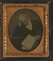 [Man resting head in hand, possibly sleeping]