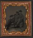 [Two boys sitting in a tangled position for an optical gag]