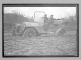 [auto tour stuck in mud]