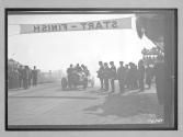 [auto at start-finish line with judges "#5"]