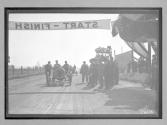 [auto at start-finish line with judges "#7"]