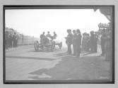 [auto at start-finish line with judges "#7"]