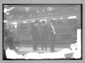 [men in front of train]