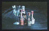 [Four bottles of liquor and a glass]