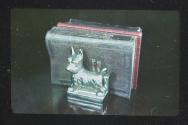 [Dog-shaped bookend]