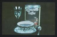 [Cup of coffee with glass, sppon, and coffee can]