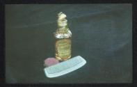 [Bottle of Vovan, mirror, and comb]
