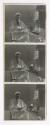 [Man seated at table with bottles]