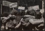 [Marchers at gay pride event, locking arms]

