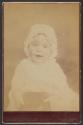 [Baby wearing bonnet and glasses]