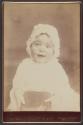 [Baby wearing glasses and bonnet]