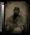 [Bearded man in uniform, seated holding cigar]