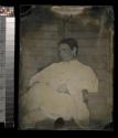 [Soldier in white uniform, seated with legs crossed]