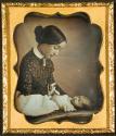 [Woman with deceased baby, figurine of a dog]