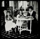 [Woman teaching two girls how to knit]