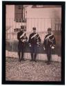 [Three soldiers in dress uniform, standing]
