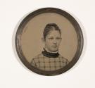 [Disc containing head and shoulders portrait of young woman in plaid dress]