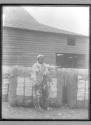 Negro with bales of cotton