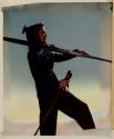 [Woman holding skis]