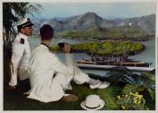 [Naval officer and young man on hillside with binoculars, overlooking battleship in bay below]