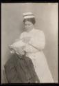 [Nurse bandaging woman's head]
