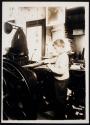 [Apprentice in small printing shop]