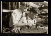 [Boy learning textile work in New England mill]