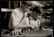 Boy learning textile work in New England mill. 1915