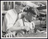 [Boy learning textile work in New England mill]