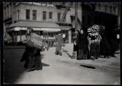 [Woman carrying take-home piecework]