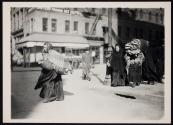 [Woman carrying homework on street]